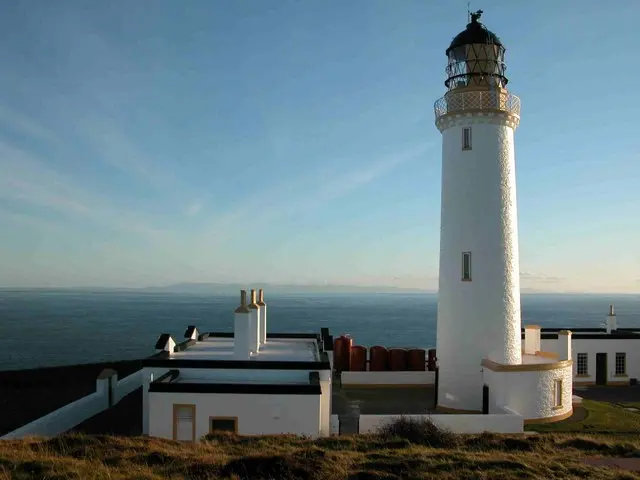 White Mull of Galloway lighthouse above grass and coastal cliffs
