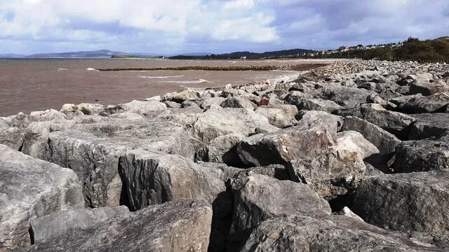 Morecambe Bay beyond coastal defence rocks at Hest Bank