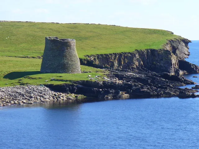 Mousa Broch across Burgi Ayre with the island cliffs beyond